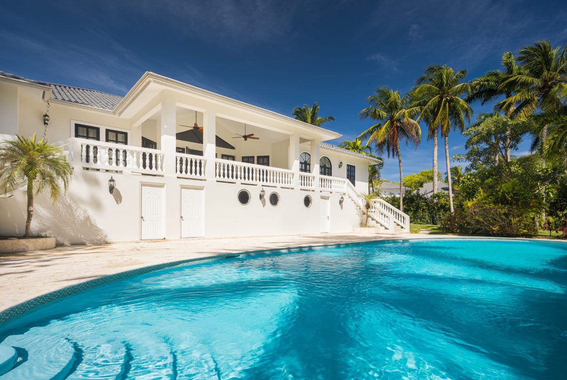buyDRproperty Luxury home with a stunning turquoise pool and palm trees in the Caribbean. Sosua Real Estate