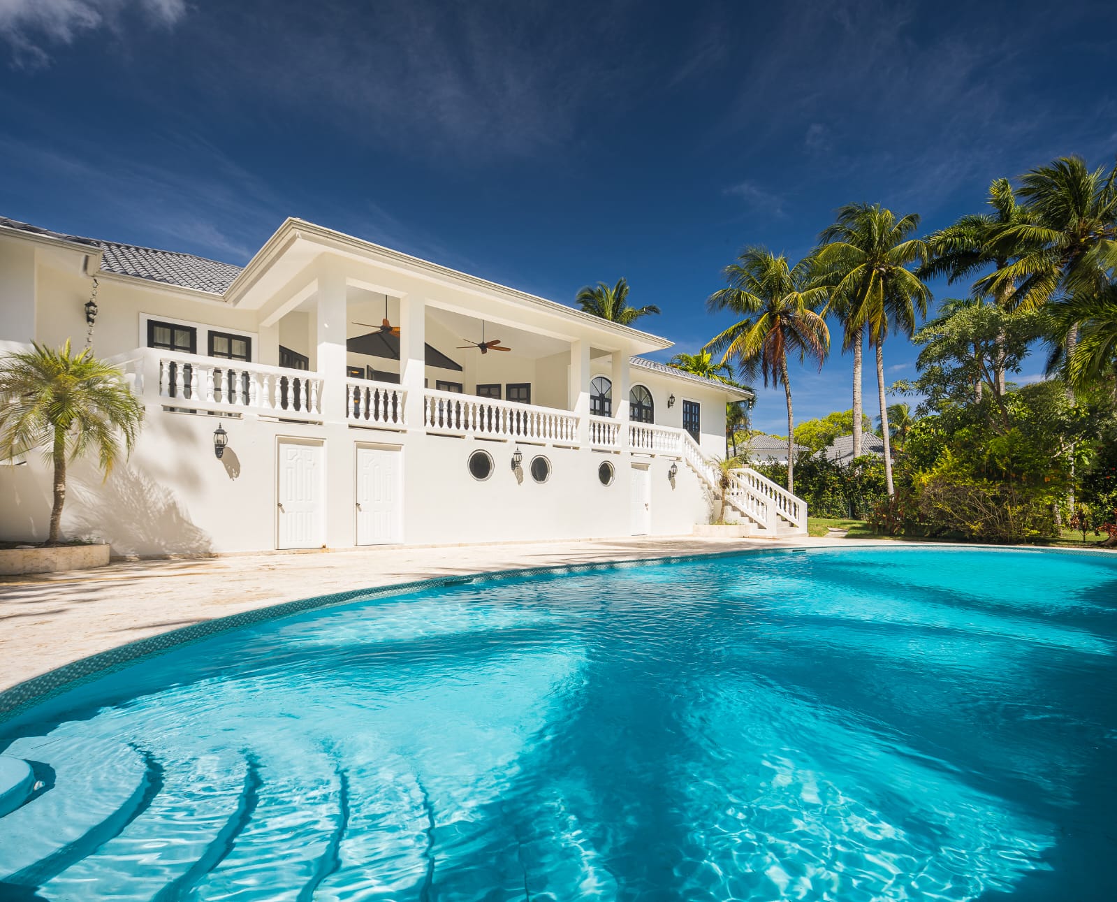 buyDRproperty Luxury home with a stunning turquoise pool and palm trees in the Caribbean. Sosua Real Estate