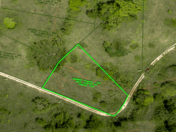 buyDRproperty Aerial view of a green-outlined land plot with surrounding trees and paths Sosua Real Estate
