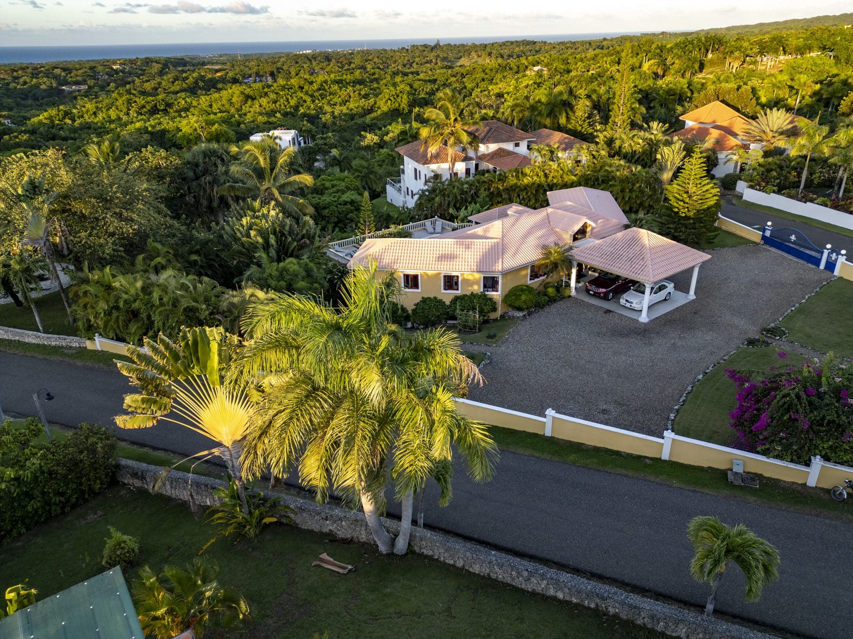 buyDRproperty Aerial view of a luxury villa for sale with ocean views in Panorama Village, surrounded by lush greenery. Sosua Real Estate