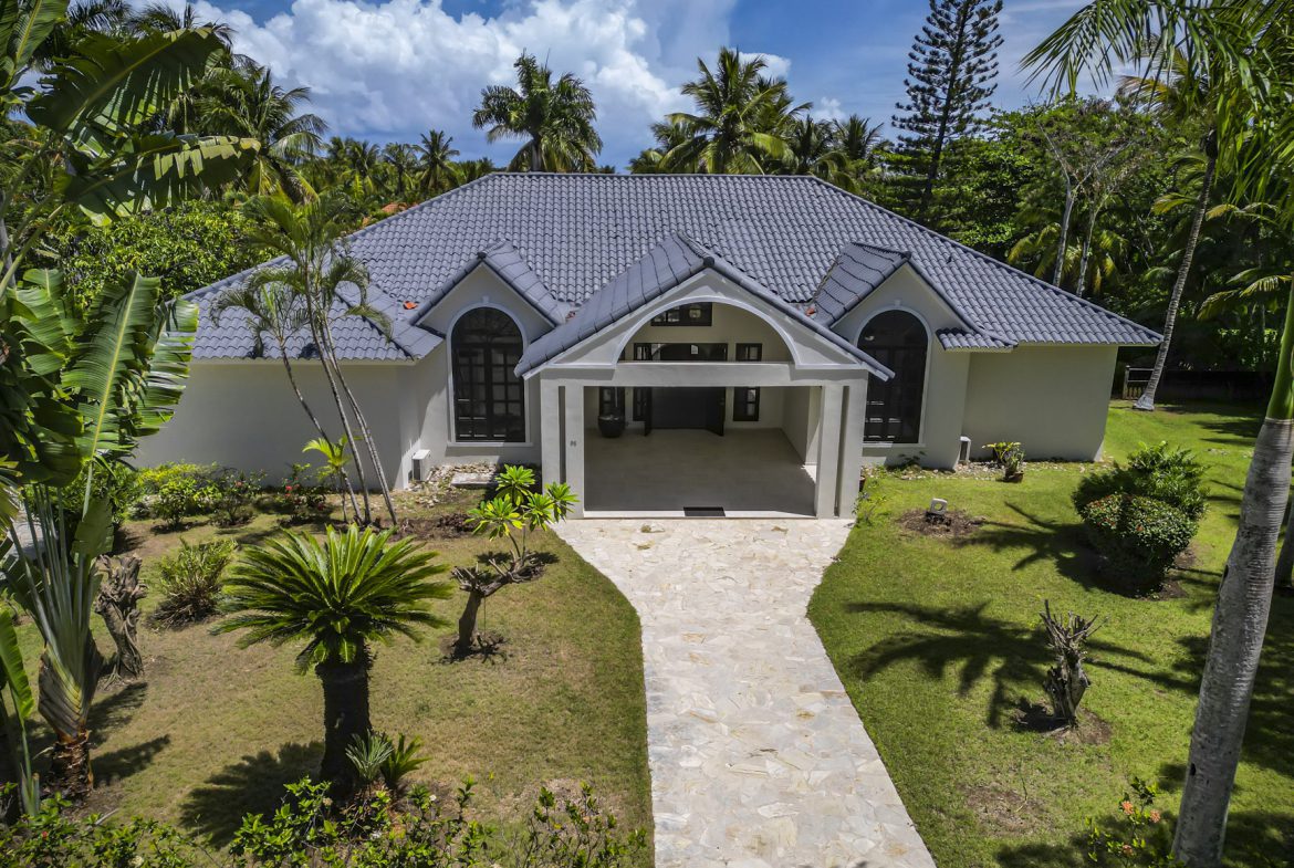 buyDRproperty Luxury villa with Caribbean architecture and lush tropical landscaping. Sosua Real Estate