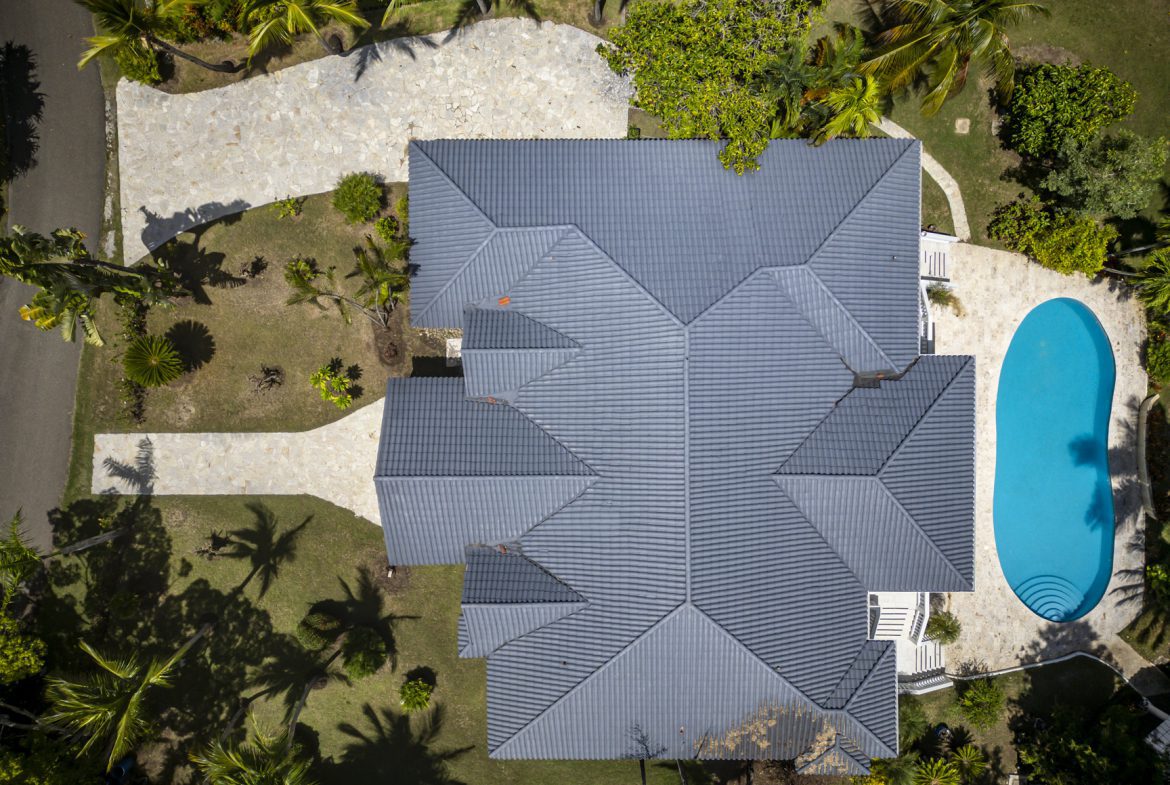 buyDRproperty Aerial view of a luxury home with a swimming pool and tropical landscaping Sosua Real Estate