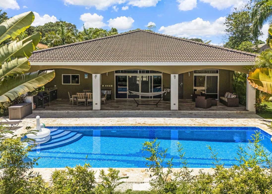 buyDRproperty Elegant villa with a pool and outdoor seating area. Sosua Real Estate