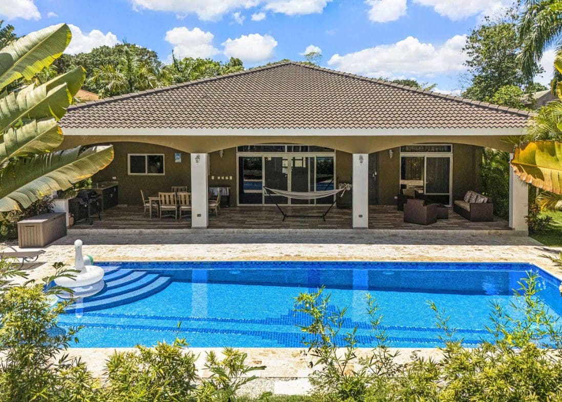 buyDRproperty Elegant villa with a pool and outdoor seating area. Sosua Real Estate