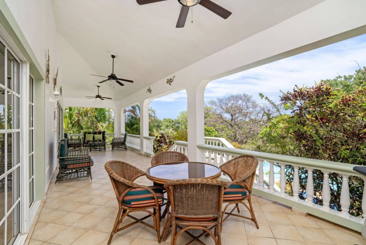 buyDRproperty Ocean view from a patio in Residential Hispaniola, overlooking lush greenery Sosua Real Estate