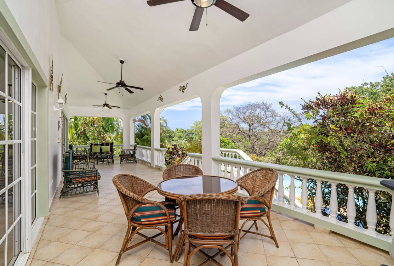 buyDRproperty Ocean view from a patio in Residential Hispaniola, overlooking lush greenery Sosua Real Estate