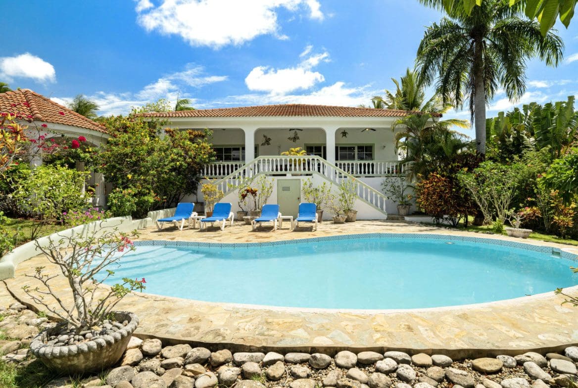buyDRproperty Luxury ocean view villa with a pool and lounge chairs in Residential Hispaniola. Sosua Real Estate