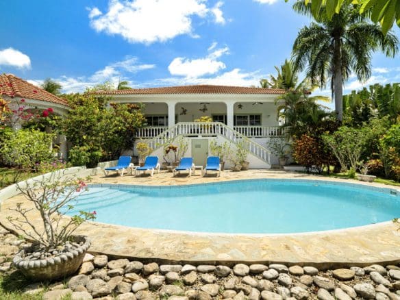 buyDRproperty Luxury ocean view villa with a pool and lounge chairs in Residential Hispaniola. Sosua Real Estate