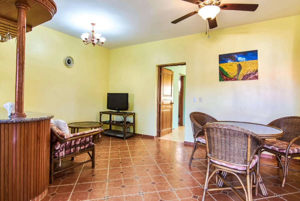 buyDRproperty Living room in a 4-BR villa for sale in Residential Hispaniola with wicker furniture and tiled floor. Sosua Real Estate