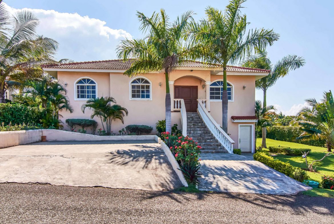 buyDRproperty Luxury villa for sale in Residential Hispaniola with palm trees and driveway Sosua Real Estate