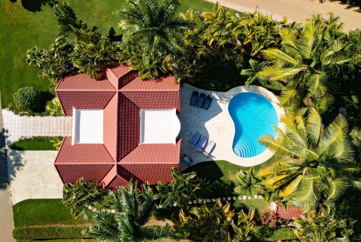 buyDRproperty Aerial view of a 3 BR Villa with a pool surrounded by palm trees. Sosua Real Estate