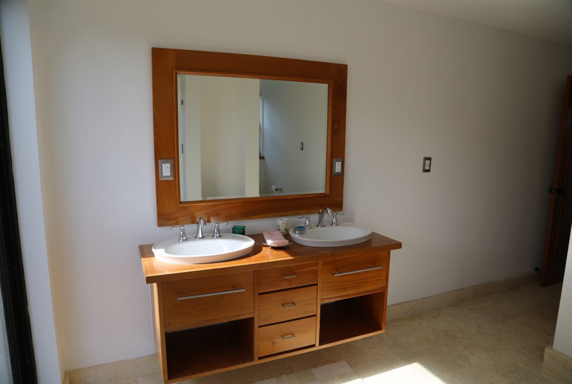 buyDRproperty Wooden bathroom vanity with double sinks and large mirror, bathroom design Sosua Real Estate