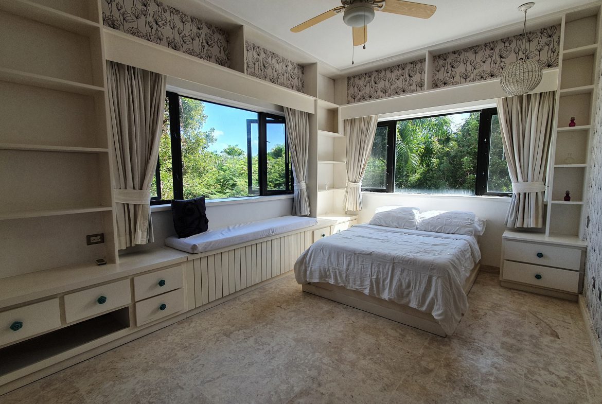 buyDRproperty Bedroom with built-in storage, window seat, and small bedroom design Sosua Real Estate