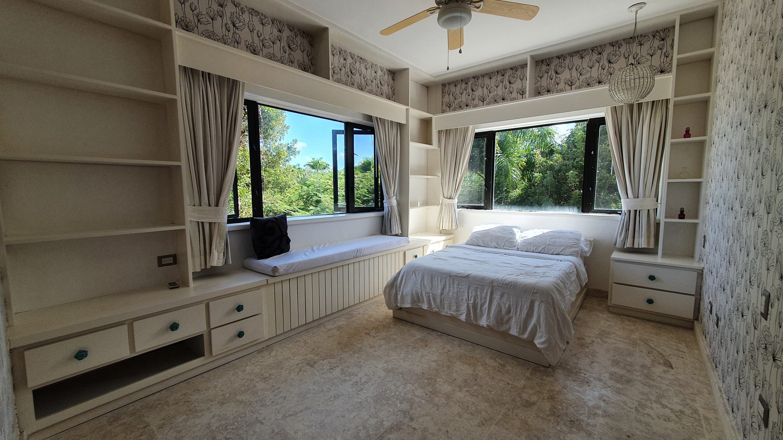 buyDRproperty Bedroom with built-in storage, window seat, and small bedroom design Sosua Real Estate
