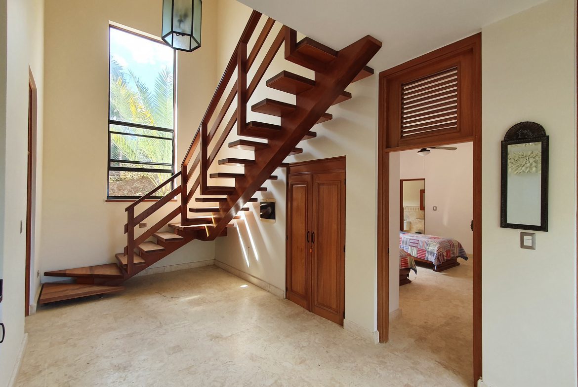 buyDRproperty Wooden staircase in a luxury home interior with natural light Sosua Real Estate