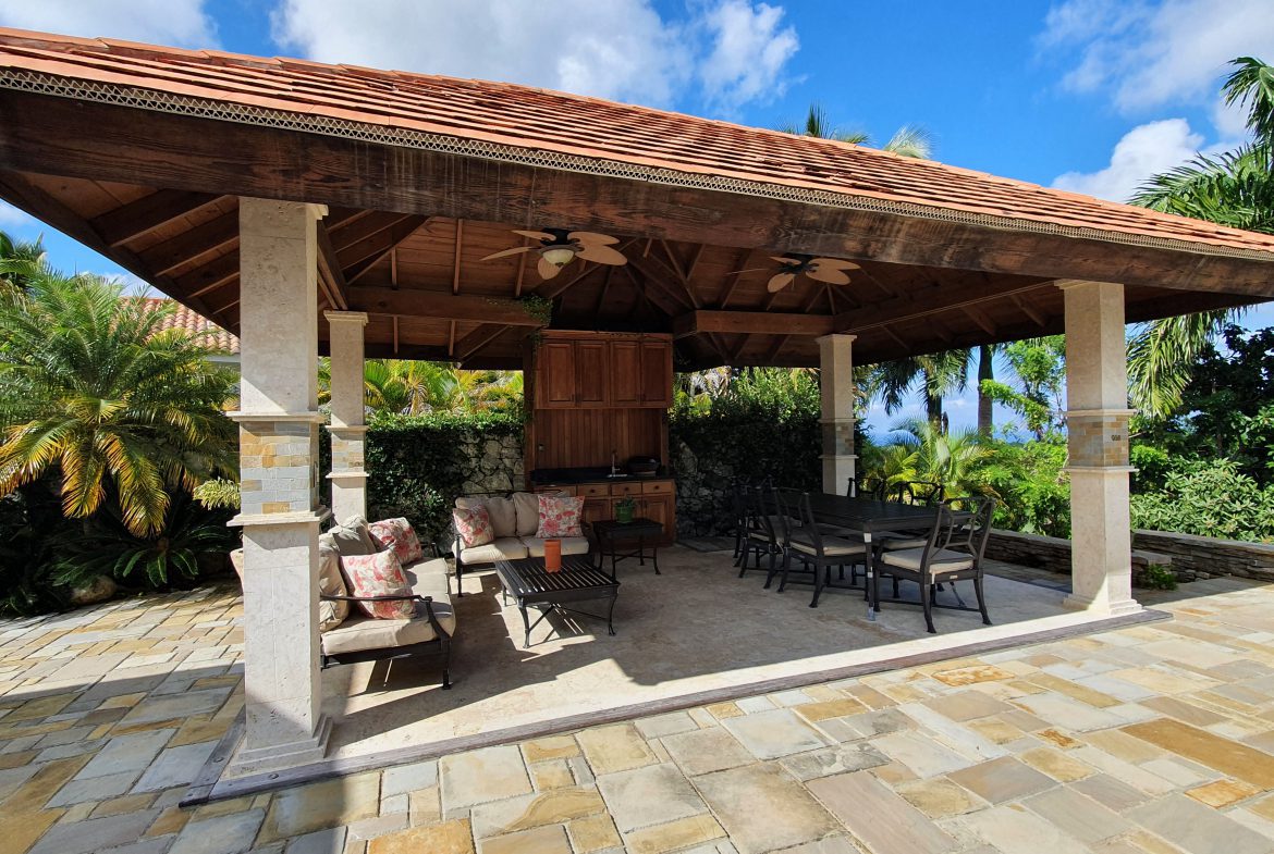 buyDRproperty Luxurious outdoor patio with gazebo, seating area, and dining table in a luxury home. Sosua Real Estate