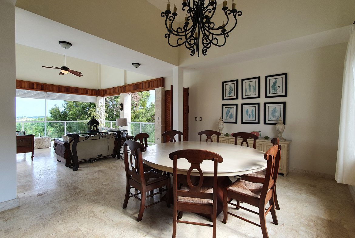 buyDRproperty Luxury dining room with round table, chandelier, and scenic view Sosua Real Estate