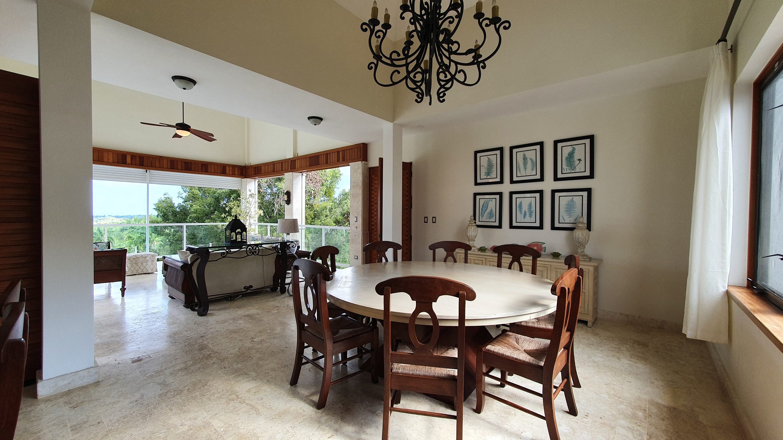 buyDRproperty Luxury dining room with round table, chandelier, and scenic view Sosua Real Estate