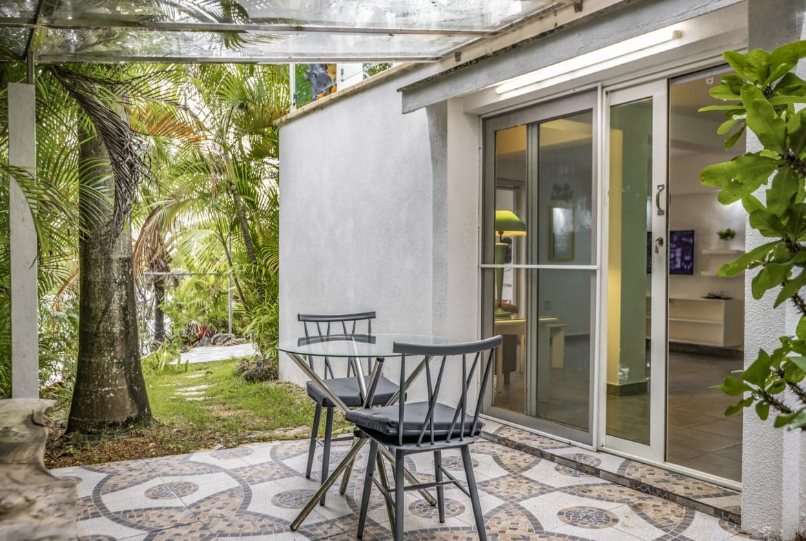 buyDRproperty Patio with table, chairs, and tropical garden view. Sosua Real Estate
