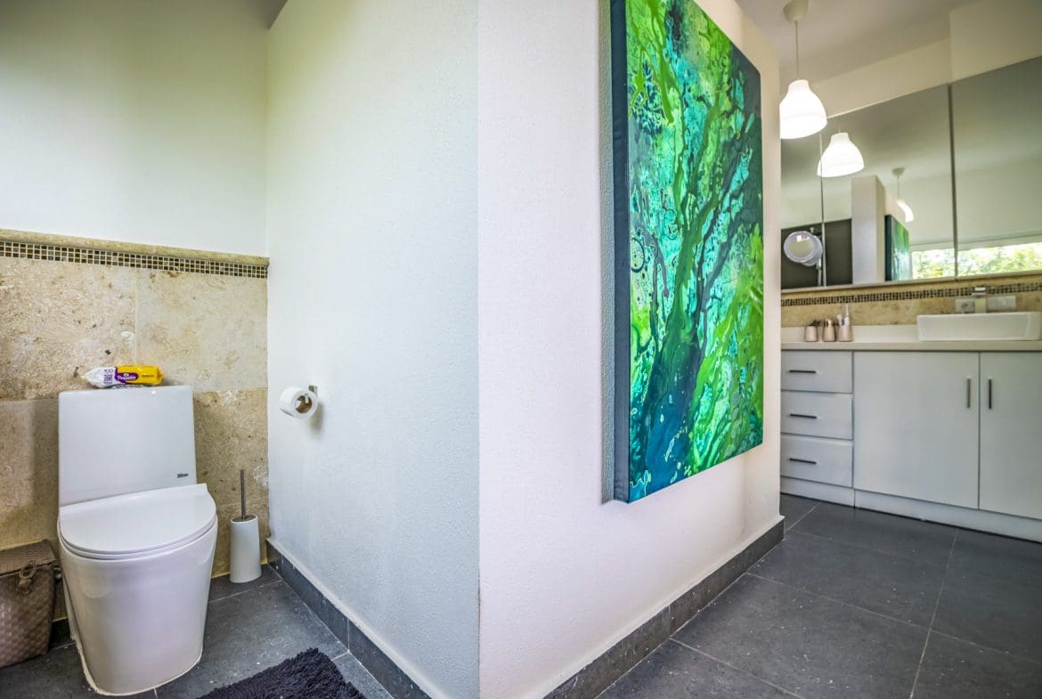 buyDRproperty Sunlight streaming through a window, illuminating a plant. Sosua Real Estate