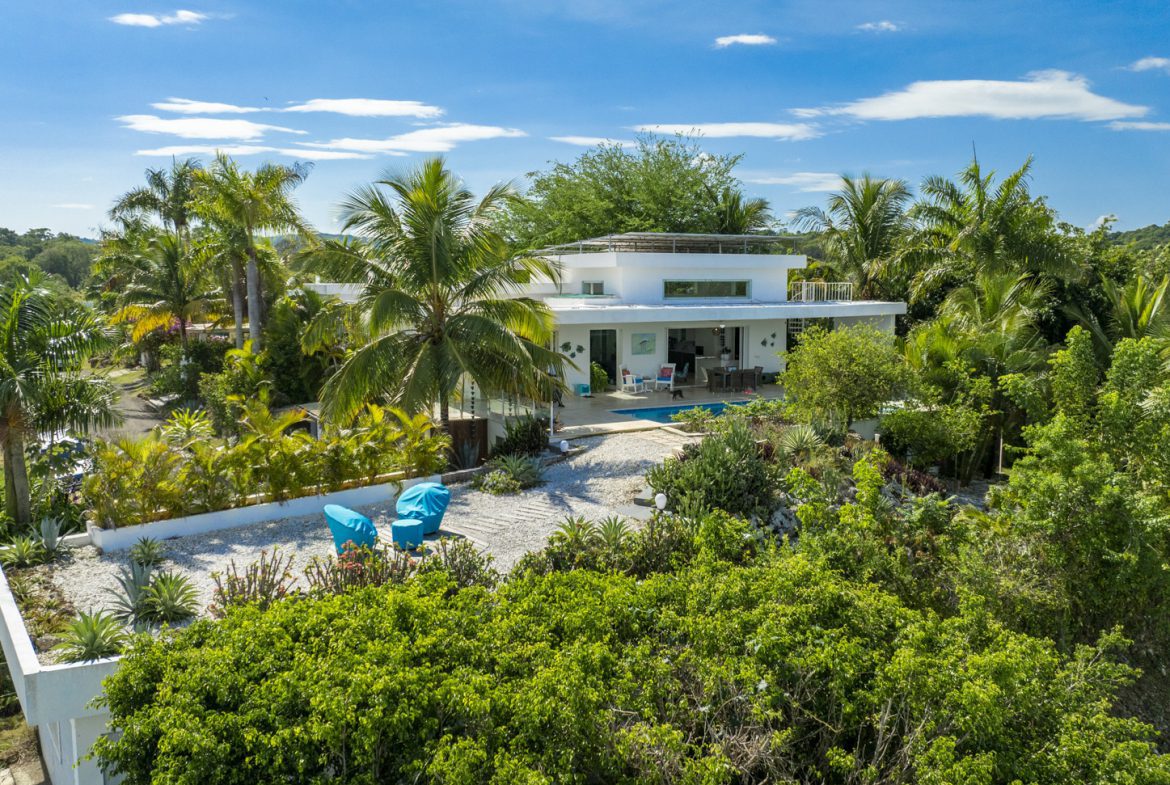 buyDRproperty Luxury villa with pool in Costa Rica, surrounded by tropical foliage. Sosua Real Estate