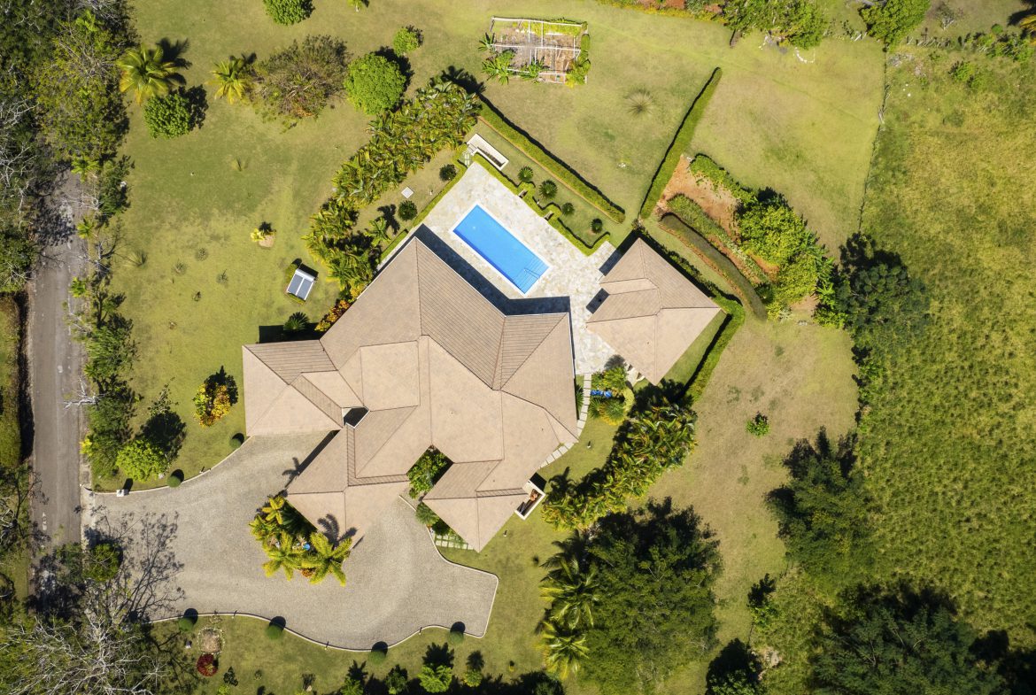 buyDRproperty Luxurious villa with pool in landscaped garden, aerial view Sosua Real Estate
