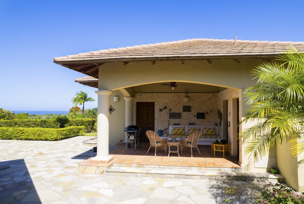 buyDRproperty Covered patio with wicker chairs, coastal decor, and ocean view. Sosua Real Estate