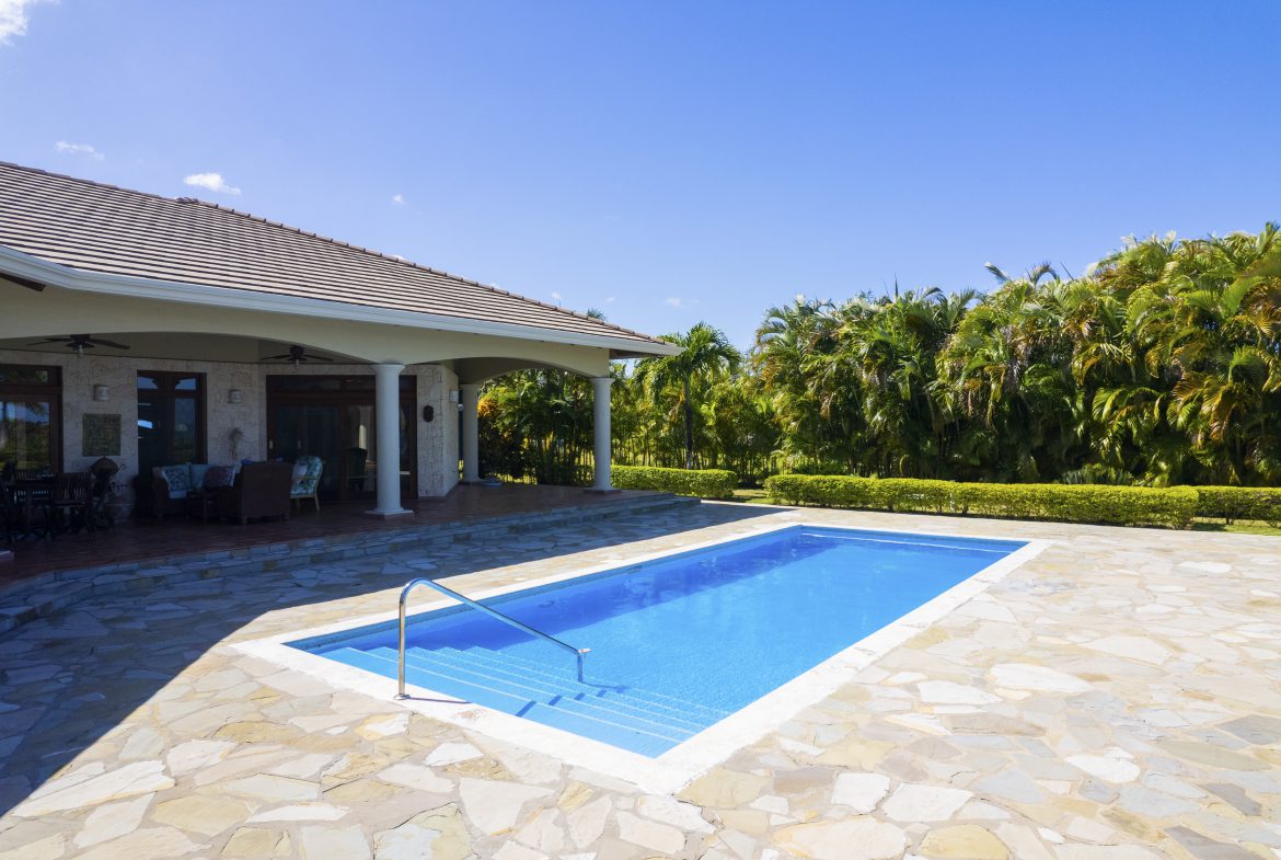 buyDRproperty Luxurious backyard with a sparkling pool and tropical landscape Sosua Real Estate