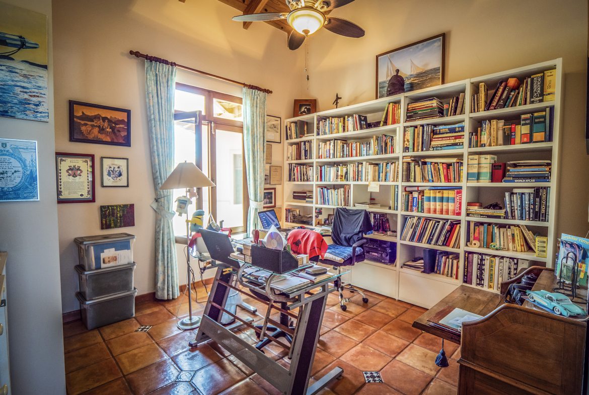 buyDRproperty Cozy home library with bookshelves and a sunny window Sosua Real Estate