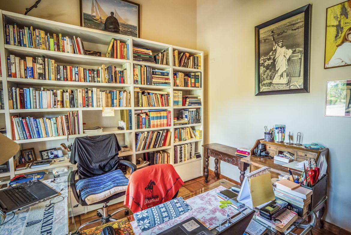 buyDRproperty Cozy home office with bookshelves and vintage decorations Sosua Real Estate