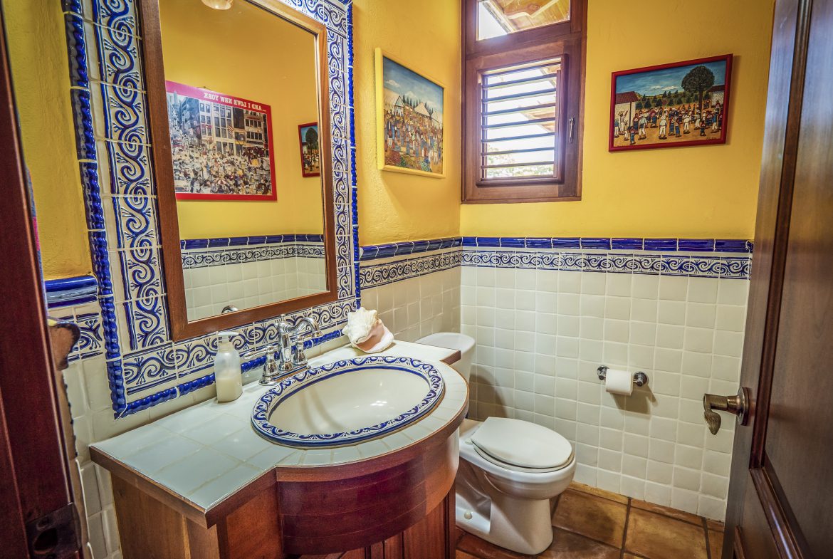 buyDRproperty Colorful bathroom with tiled sink and decorative wall art Sosua Real Estate