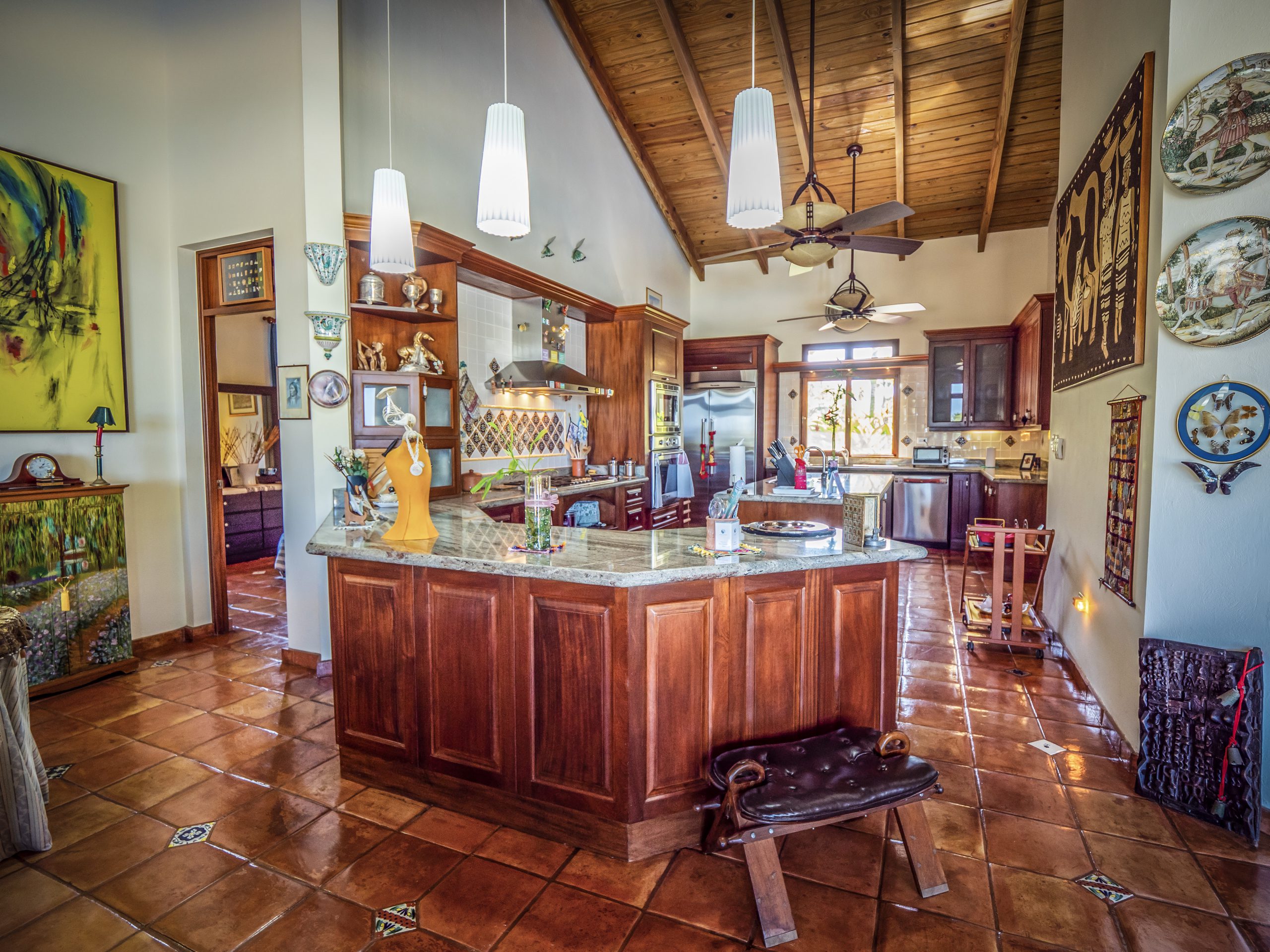 buyDRproperty Rustic kitchen with wooden cabinets and hanging lights Sosua Real Estate