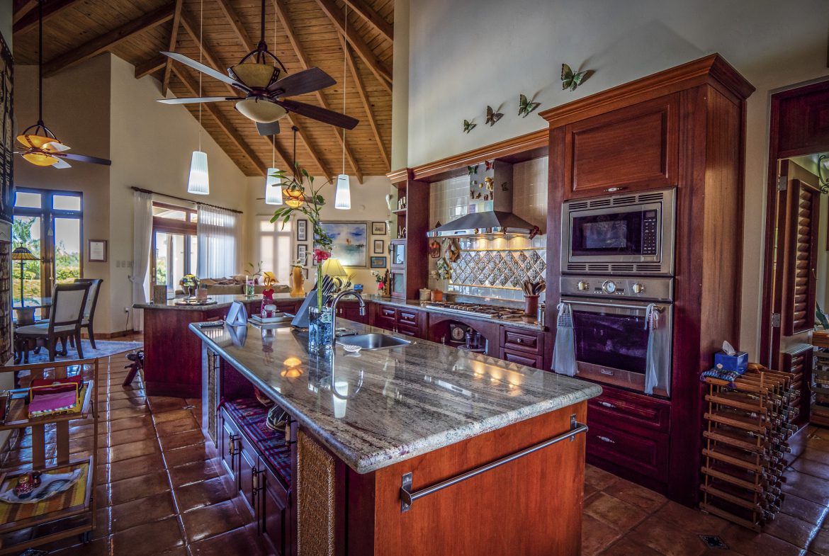 buyDRproperty Rustic kitchen with wooden cabinets and high ceilings Sosua Real Estate