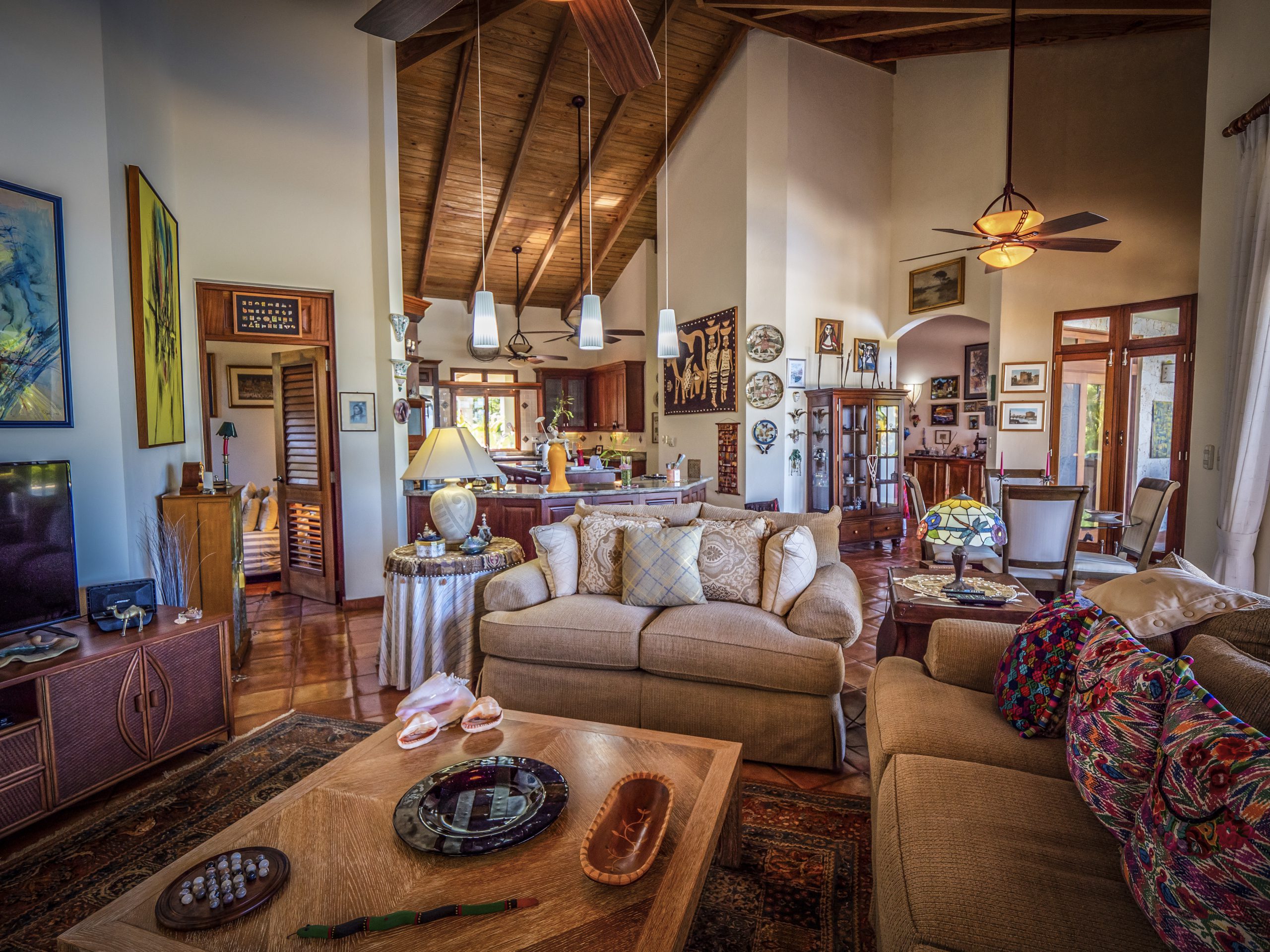 buyDRproperty Spacious living room with high wooden ceiling and cozy seating area Sosua Real Estate