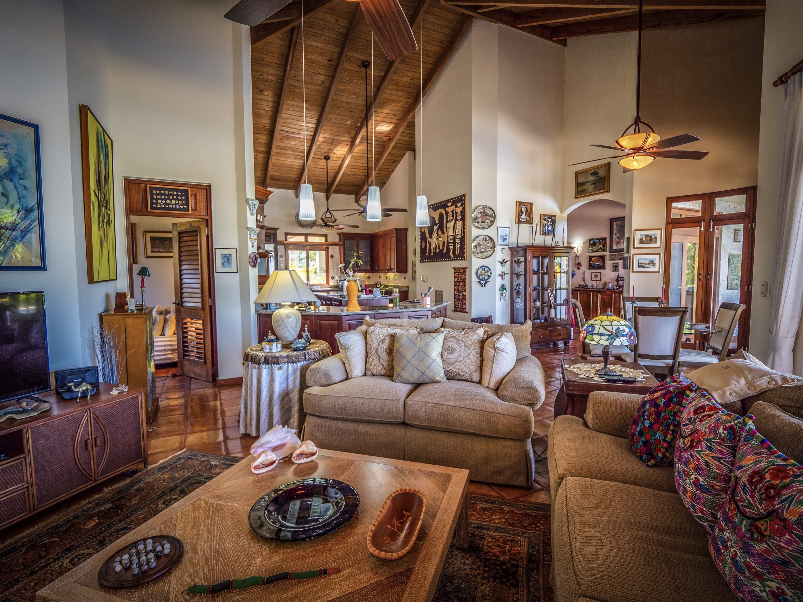 buyDRproperty Spacious living room with high wooden ceiling and cozy seating area Sosua Real Estate