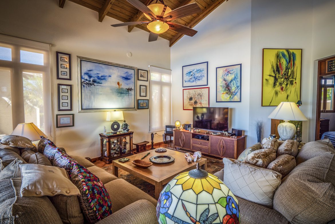 buyDRproperty Cozy living room with colorful art and ceiling fan Sosua Real Estate