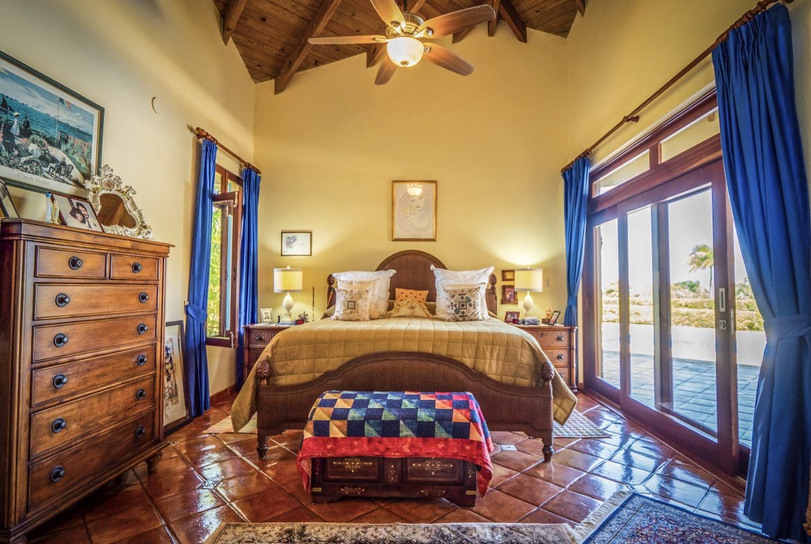 buyDRproperty Cozy bedroom with rustic wooden ceiling and large windows Sosua Real Estate