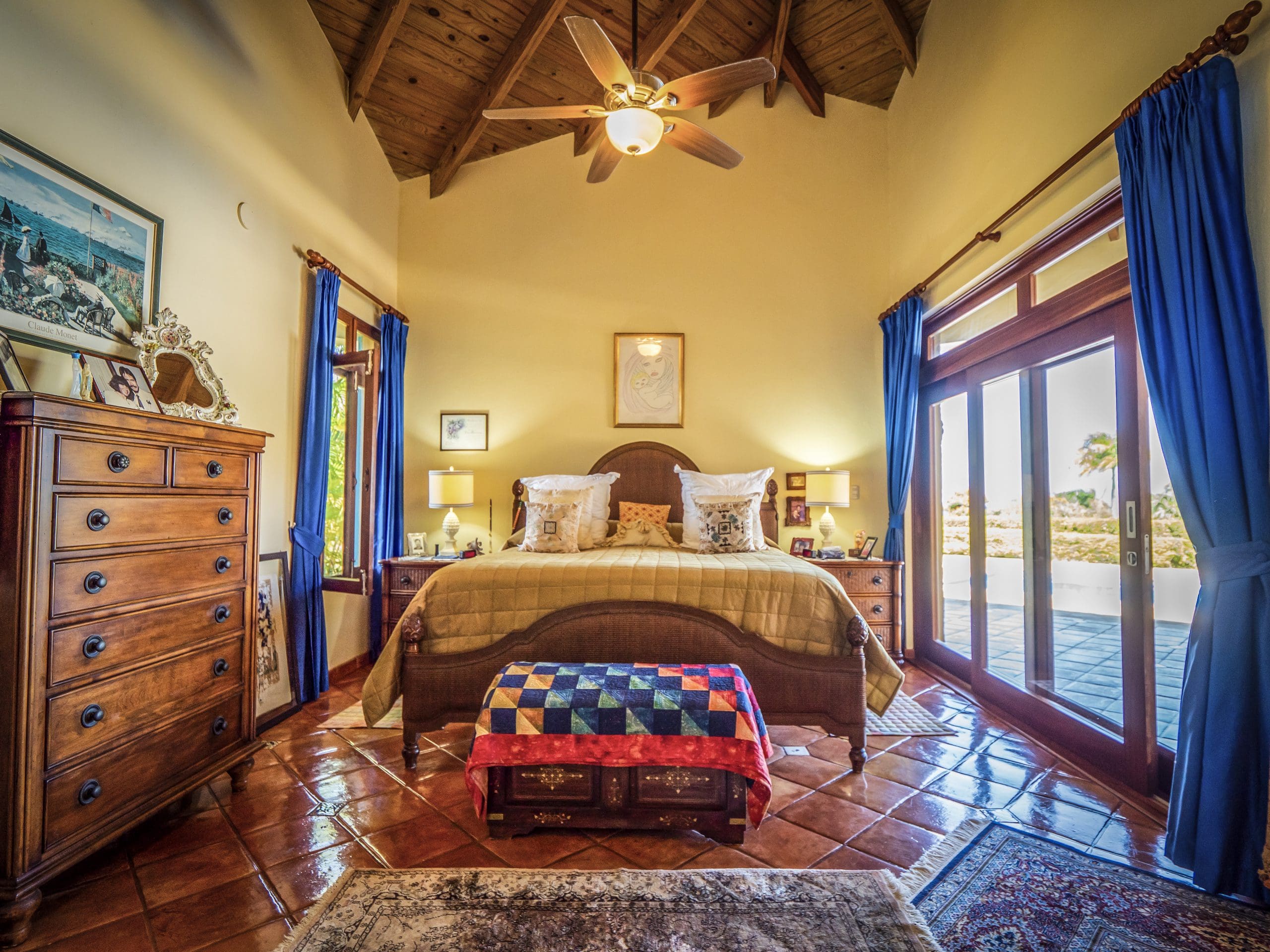 buyDRproperty Cozy bedroom with rustic wooden ceiling and large windows Sosua Real Estate