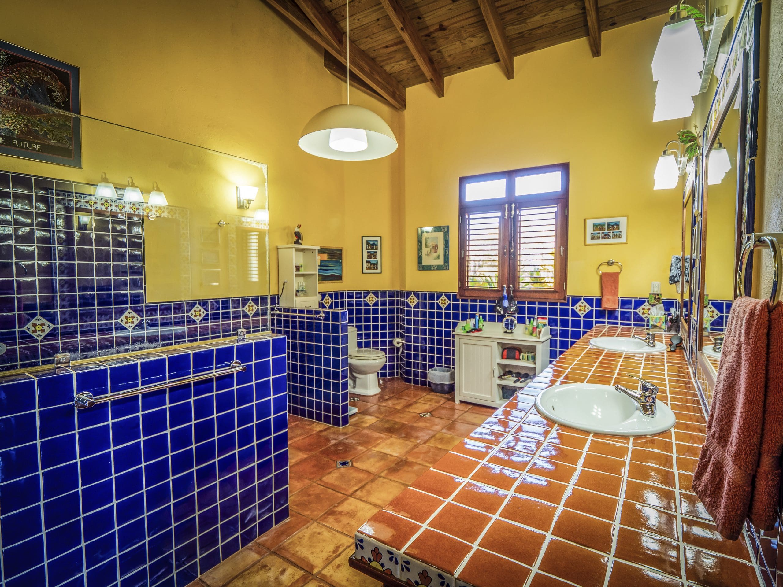 buyDRproperty Rustic bathroom with blue tile walls and orange tile countertops Sosua Real Estate