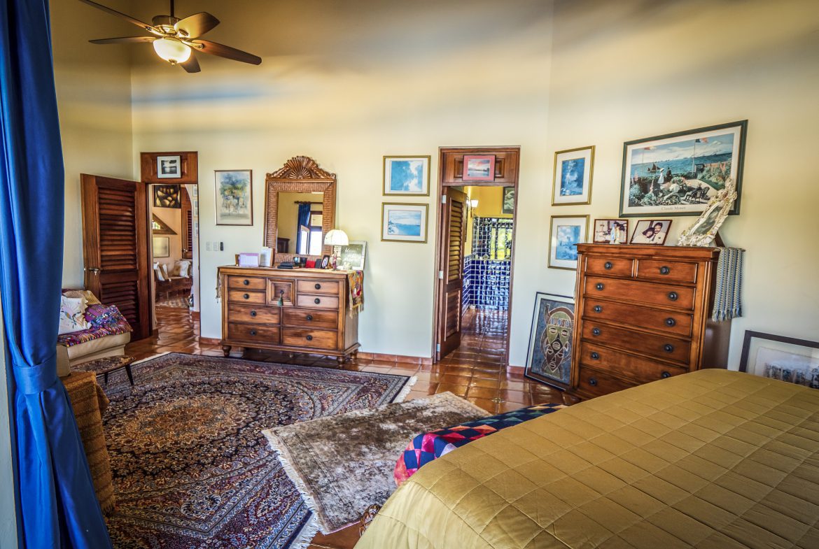 buyDRproperty Spacious bedroom with warm lighting and wooden furniture Sosua Real Estate