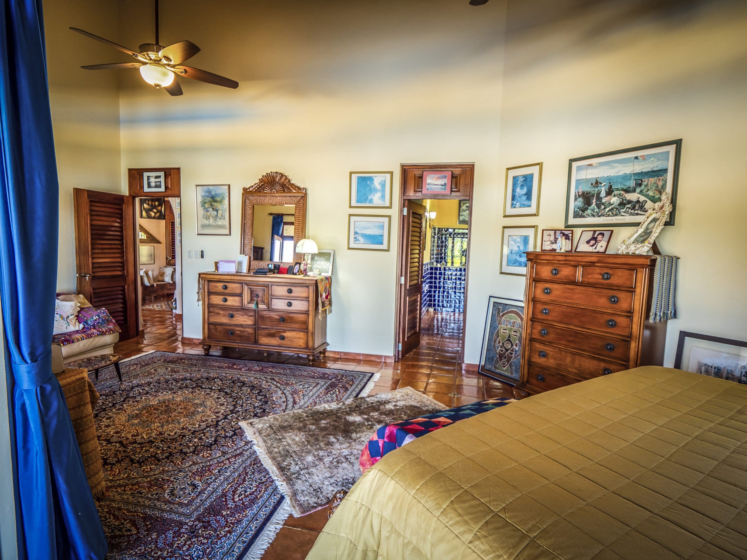 buyDRproperty Spacious bedroom with warm lighting and wooden furniture Sosua Real Estate