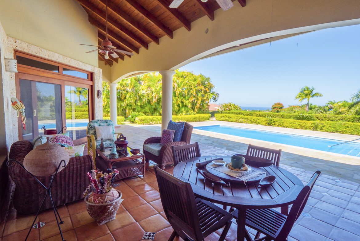 buyDRproperty Terrace with dining set overlooking pool and garden Sosua Real Estate