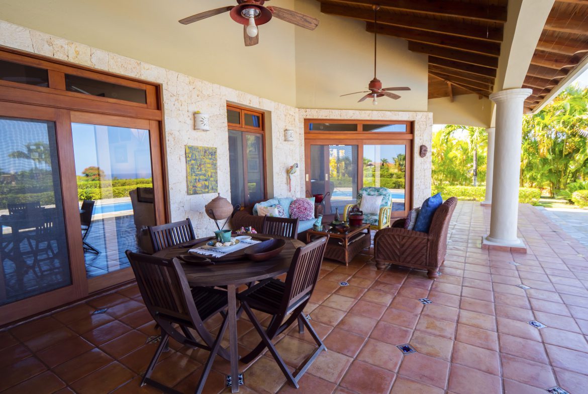 buyDRproperty Patio with wooden furniture and ceiling fans overlooking lush greenery Sosua Real Estate
