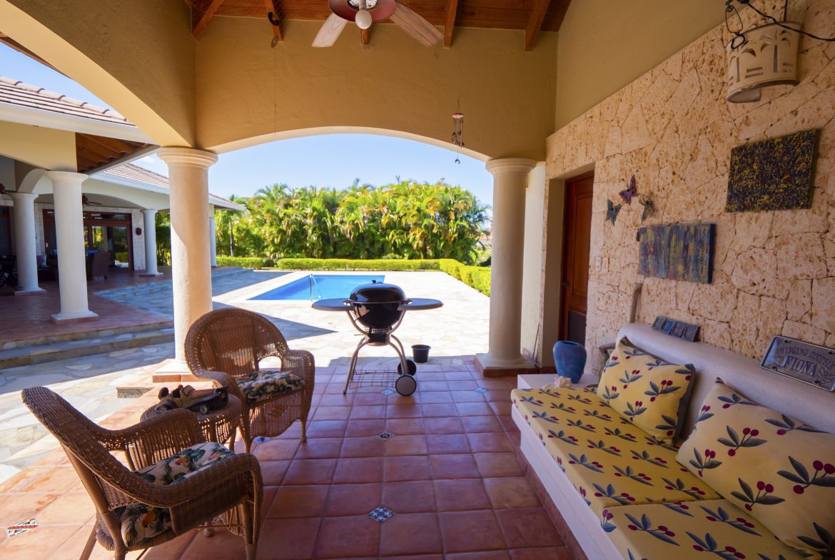 buyDRproperty Covered patio with wicker chairs, a grill, and pool view Sosua Real Estate