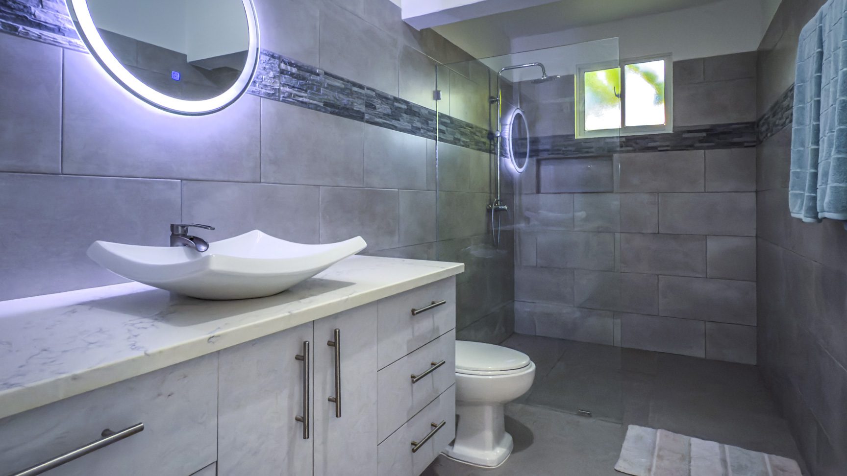 buyDRproperty Modern bathroom with vessel sink, LED mirror, and glass shower. Sosua Real Estate