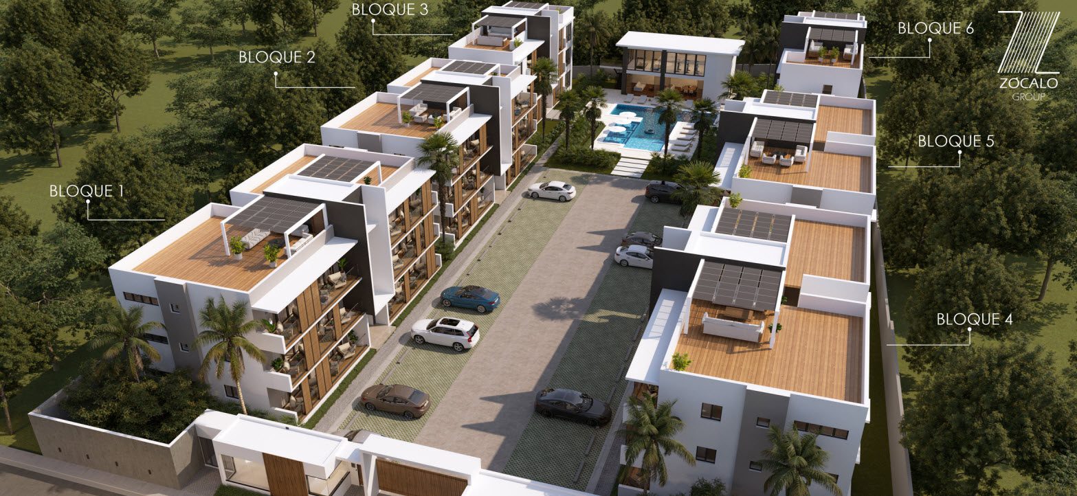 buyDRproperty Aerial view of Zocalo Group apartment complex with multiple buildings, a pool, and parking. Sosua Real Estate