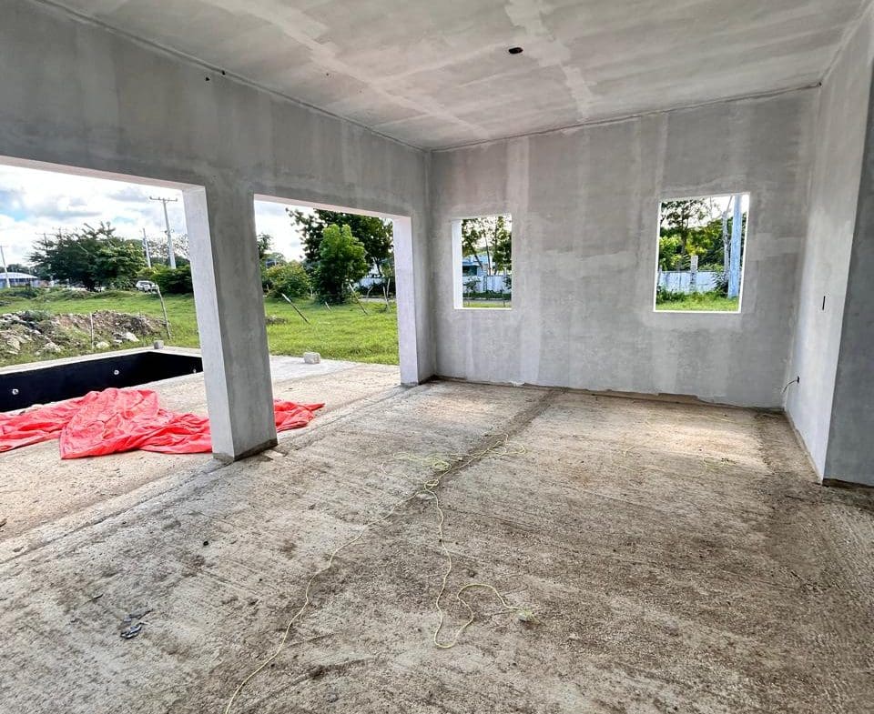 buyDRproperty Unfinished interior of a new house with concrete floors and walls, awaiting completion. Sosua Real Estate