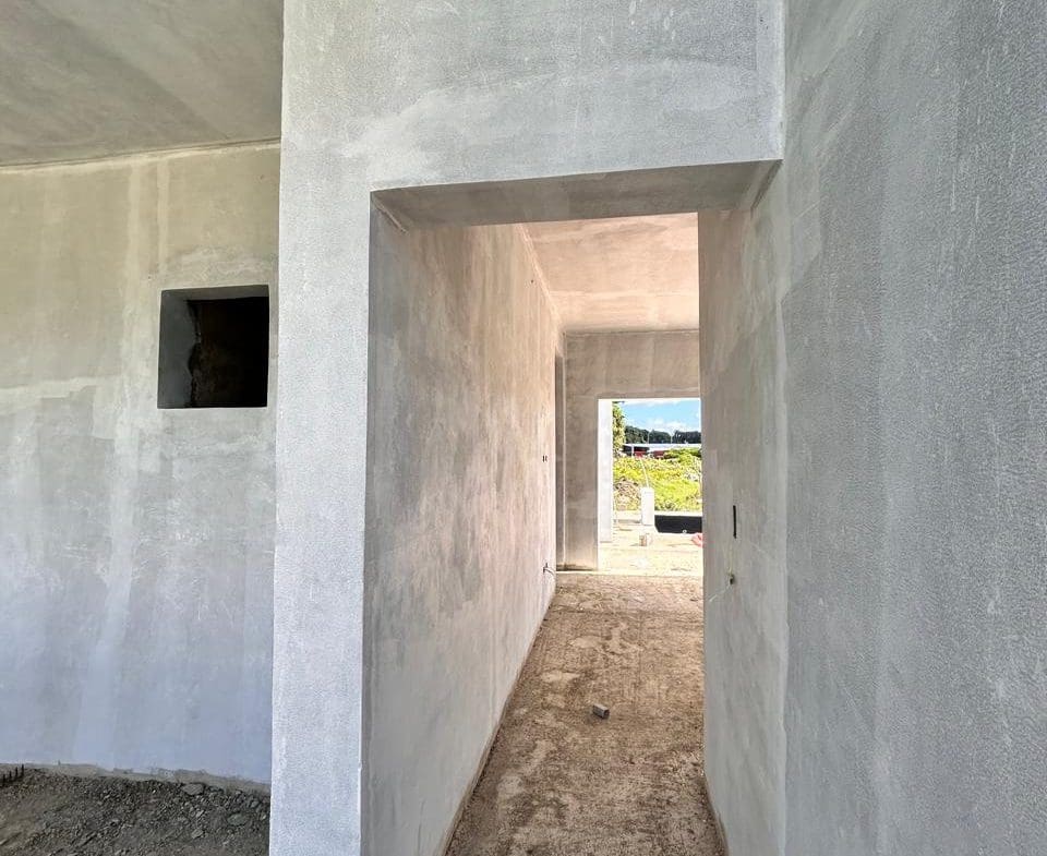 buyDRproperty Unfinished interior of a building with concrete walls and a doorway leading to an outdoor area. Sosua Real Estate