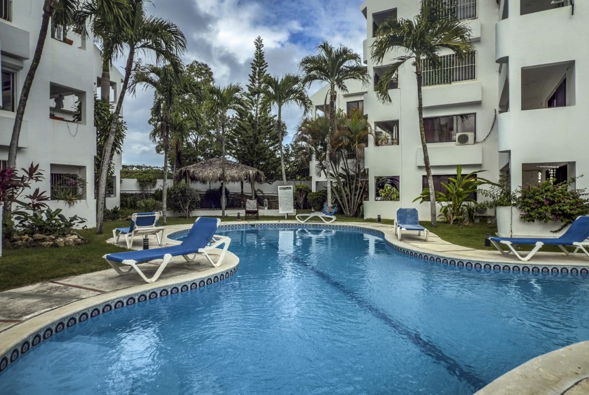 buyDRproperty Sosúa condo complex pool with lounge chairs; great value playa property. Sosua Real Estate