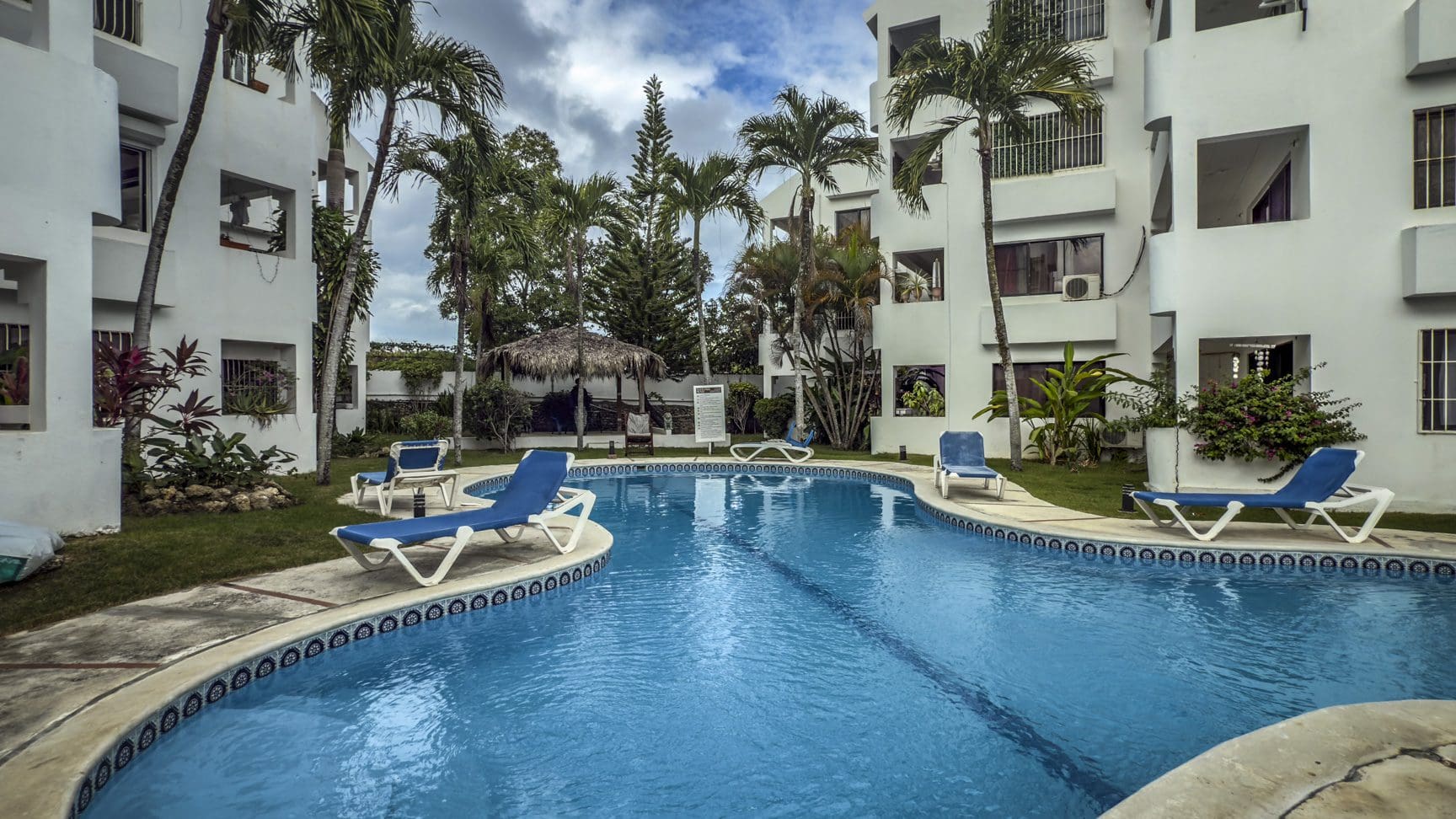 buyDRproperty Sosúa condo complex pool with lounge chairs; great value playa property. Sosua Real Estate
